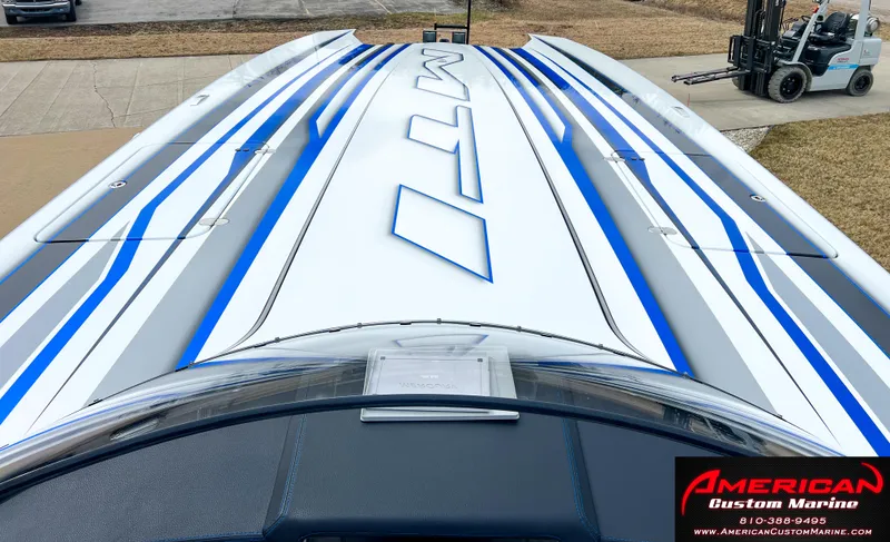 Slide: The Image of MTI 390X boat 2022 with blue and white stripes, American Custom Marine. - 39