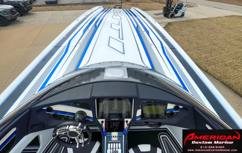 Slide: The Image of 2022 MTI 390X boat with sleek cockpit and blue stripes. - 40