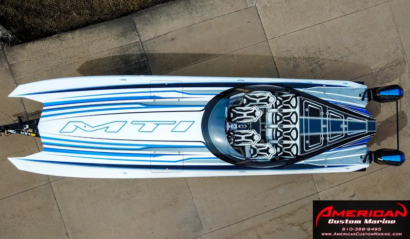 Slide: The Image of Aerial view of a 2022 MTI 390X boat, blue and white design. - 46