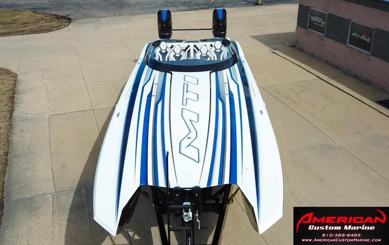 Slide: The Image of MTI 390X 2022 boat with blue stripes, American Custom Marine. - 49