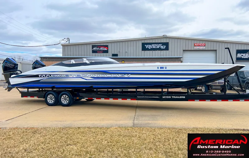 Slide: The Image of MTI 390X 2022 speedboat on trailer in front of workshop. - 6