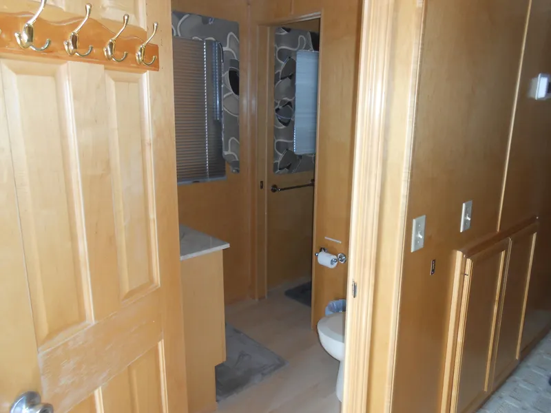 Slide: The Image of Sumerset 7016 2000 model bathroom with wooden door and wall hooks. - 13