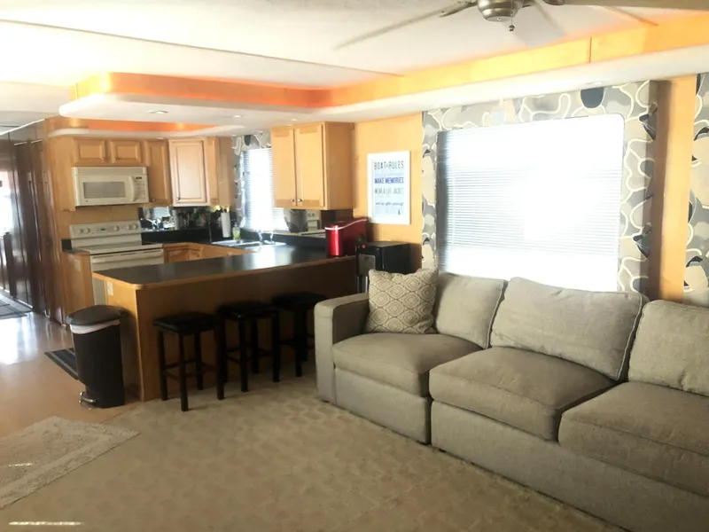 Slide: The Image of 2000 Sumerset 7016 houseboat interior with modern kitchen and cozy living area. - 16