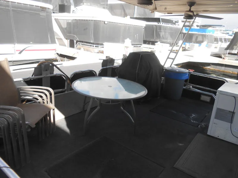 Slide: The Image of Outdoor deck of a 2000 Sumerset 7016 houseboat with table and chairs. - 18