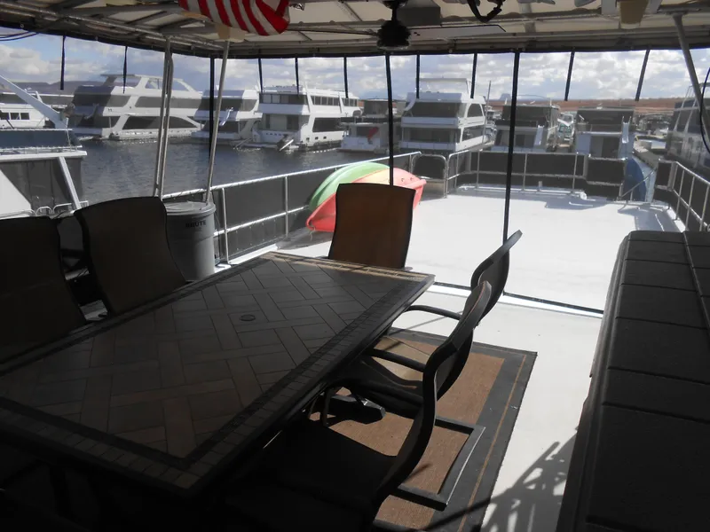 Slide: The Image of Outdoor seating area on a 2000 Sumerset 7016 houseboat with marina view. - 19