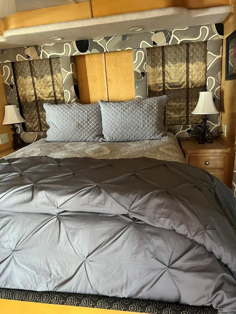 Slide: The Image of Cozy bedroom in a 2000 Sumerset 7016 houseboat with modern decor. - 2