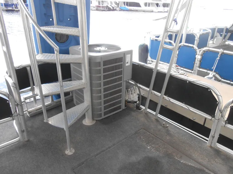 Slide: The Image of Sumerset 7016 houseboat 2000 model with spiral staircase and air conditioning unit. - 21