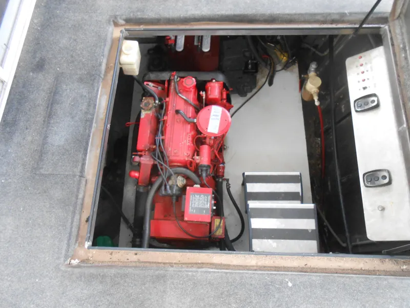 Slide: The Image of Engine compartment of a 2000 Sumerset 7016 houseboat with red engine and control panel. - 23