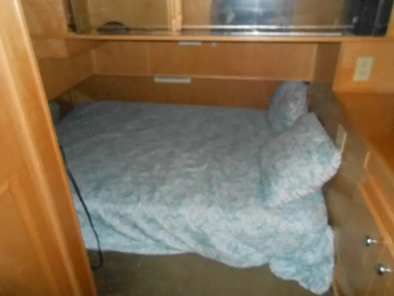 Slide: The Image of Small bedroom with a bed in a 2000 Sumerset 7016 houseboat. - 5
