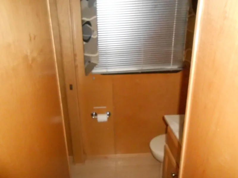 Slide: The Image of Sumerset 7016 2000 houseboat bathroom with wooden interior and window blinds. - 7