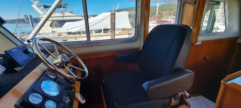 Slide: The Image of Control panel of 1999 Rozema Boat Works Custom 40 with steering wheel and navigation equipment. - 11