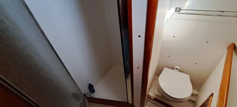 Slide: The Image of Interior of 1999 Rozema Boat Works Custom 40, featuring helm, cabin, and wood flooring. - 14