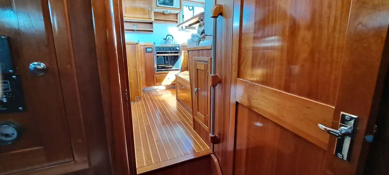 Slide: The Image of Luxurious cabin interior of 1999 Rozema Boat Works Custom 40 with wood paneling and cozy bed. - 17