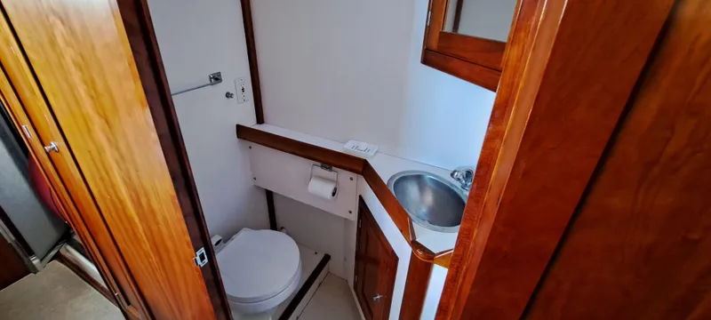 Slide: The Image of Interior of 1999 Rozema Boat Works Custom 40, featuring wooden trim and towel rack. - 21