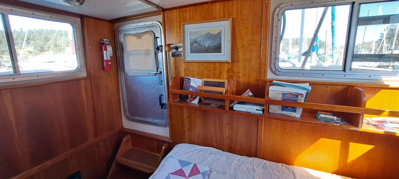 Slide: The Image of Cozy cabin interior of 1999 Rozema Boat Works Custom 40 with wooden finish and bed. - 23