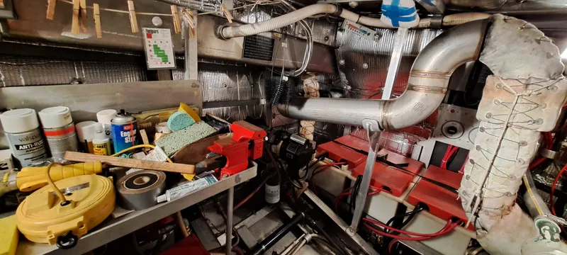 Slide: The Image of Engine room of 1999 Rozema Boat Works Custom 40, showcasing mechanical components and wiring. - 26