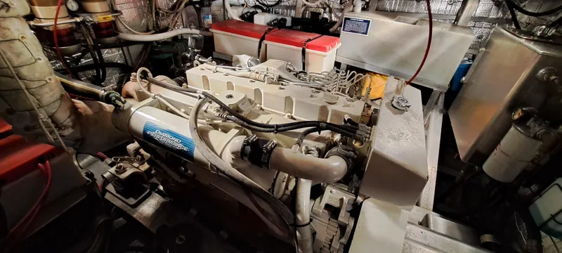 Slide: The Image of Engine room of 1999 Rozema Boat Works Custom 40, showcasing mechanical components and wiring. - 27