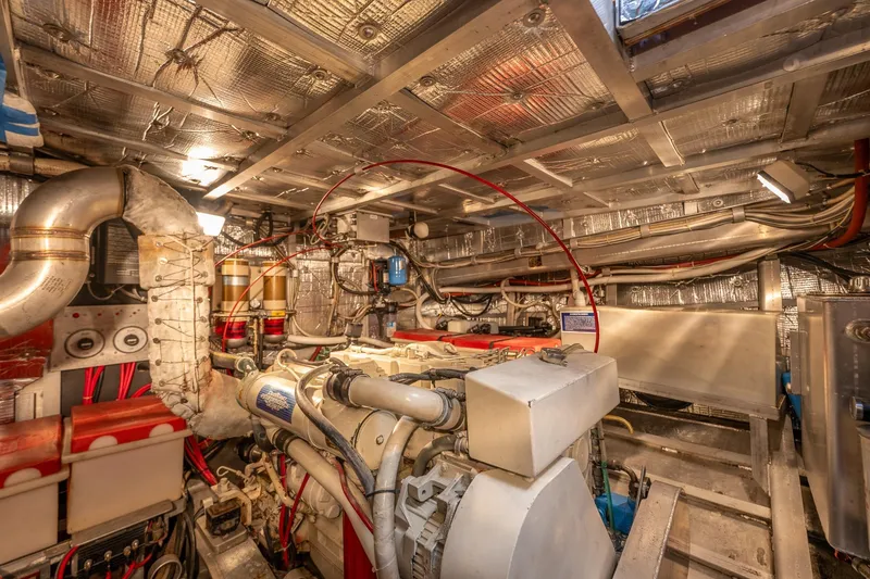 Slide: The Image of Engine room of 1999 Rozema Boat Works Custom 40, showcasing machinery and wiring. - 28