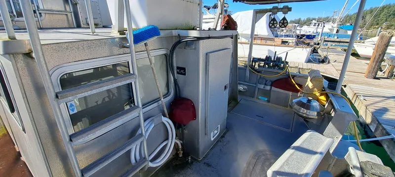 Slide: The Image of 1999 Rozema Boat Works Custom 42 docked, showcasing deck and equipment. - 3