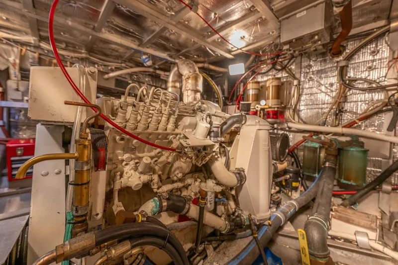 Slide: The Image of Engine room of 1999 Rozema Boat Works Custom 40, showcasing complex machinery and wiring. - 31