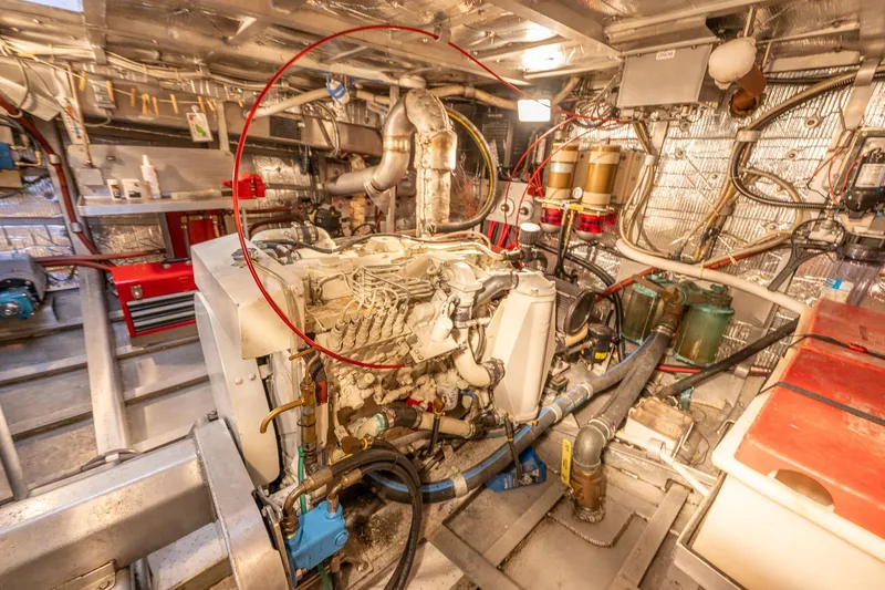 Slide: The Image of Engine room of 1999 Rozema Boat Works Custom 40, showcasing mechanical components and wiring. - 32