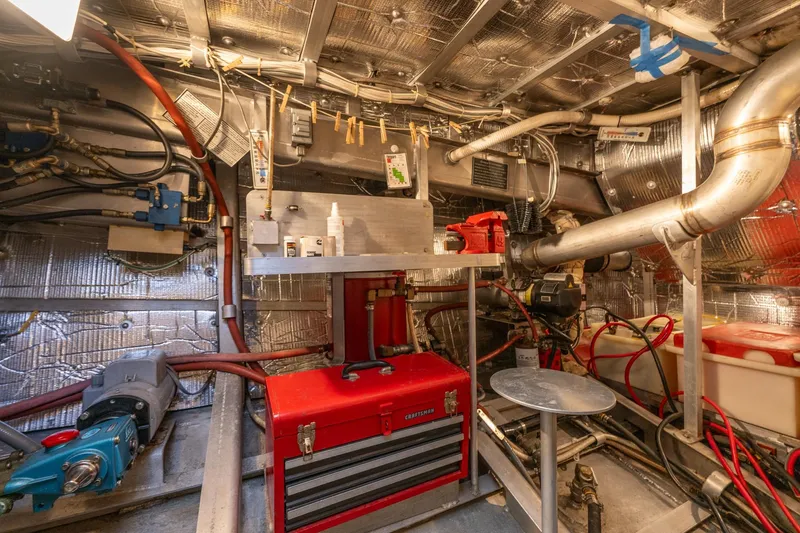 Slide: The Image of Engine room of 1999 Rozema Boat Works Custom 40, featuring tools and equipment. - 33