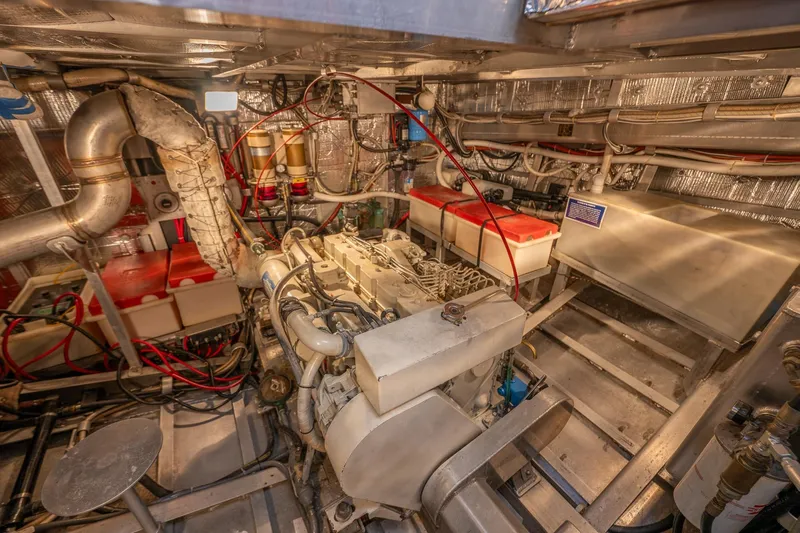 Slide: The Image of Engine room of 1999 Rozema Boat Works Custom 40, showcasing mechanical components and wiring. - 34