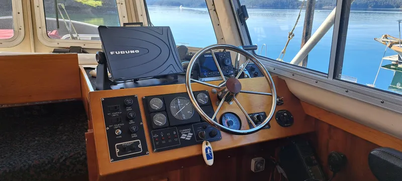 Slide: The Image of Cozy cabin interior of 1999 Rozema Boat Works Custom 40 with wood paneling and nautical decor. - 5