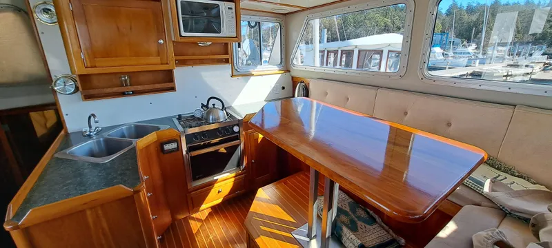 Slide: The Image of Interior of 1999 Rozema Boat Works Custom 40, featuring seating and helm area. - 9