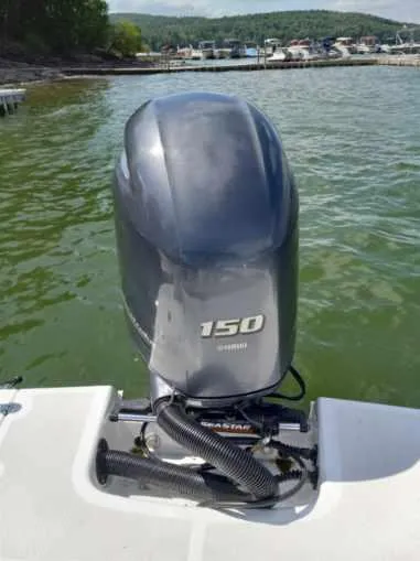 Slide: The Image of 2022 Four Winns HD2 boat with a 150 horsepower Yamaha outboard motor on a lake. - 13