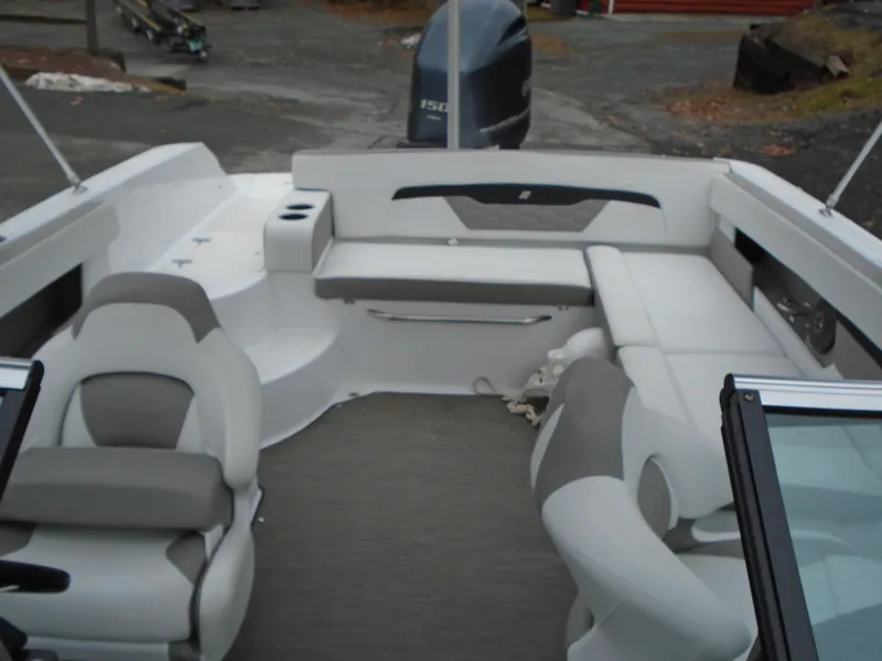 Slide: The Image of 2022 Four Winns HD2 boat interior with seating and outboard motor. - 16