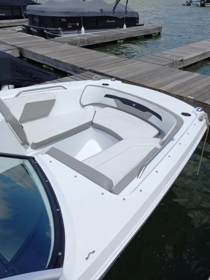 Slide: The Image of 2022 Four Winns HD2 boat docked, featuring spacious bow seating. - 5