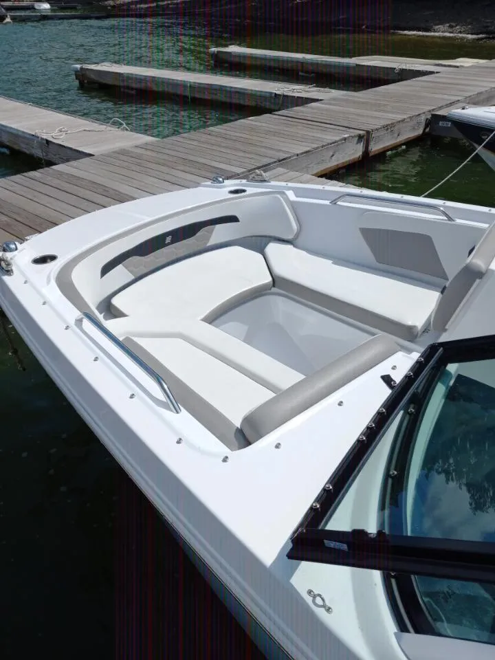 Slide: The Image of 2022 Four Winns HD2 boat with white seating at a dock. - 7