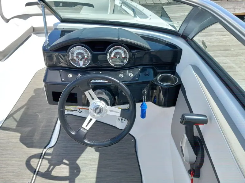 Slide: The Image of 2022 Four Winns HD2 boat dashboard with steering wheel and instrument panel. - 8