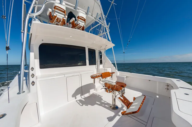 Slide: The Image of 2005 Viking Convertible yacht with fishing chair, open sea view, clear blue sky. - 11