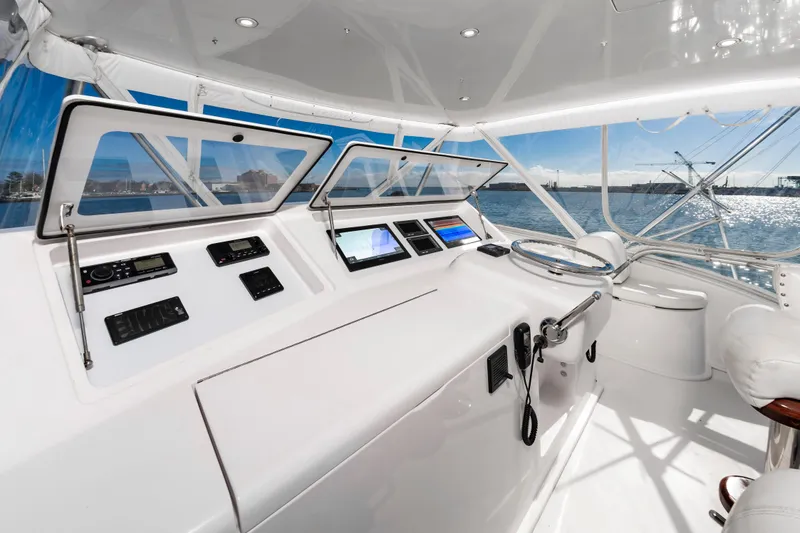 Slide: The Image of 2005 Viking Convertible yacht helm with modern navigation equipment and panoramic ocean view. - 15