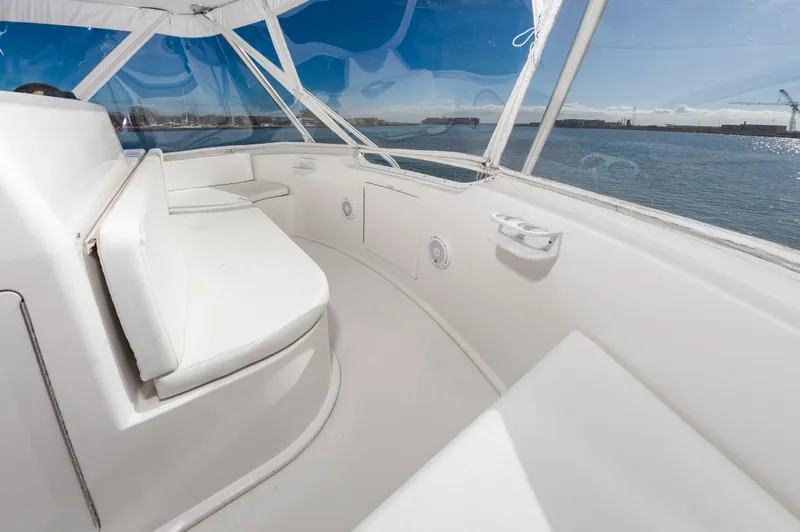 Slide: The Image of 2005 Viking Convertible boat interior with white seating and ocean view. - 18