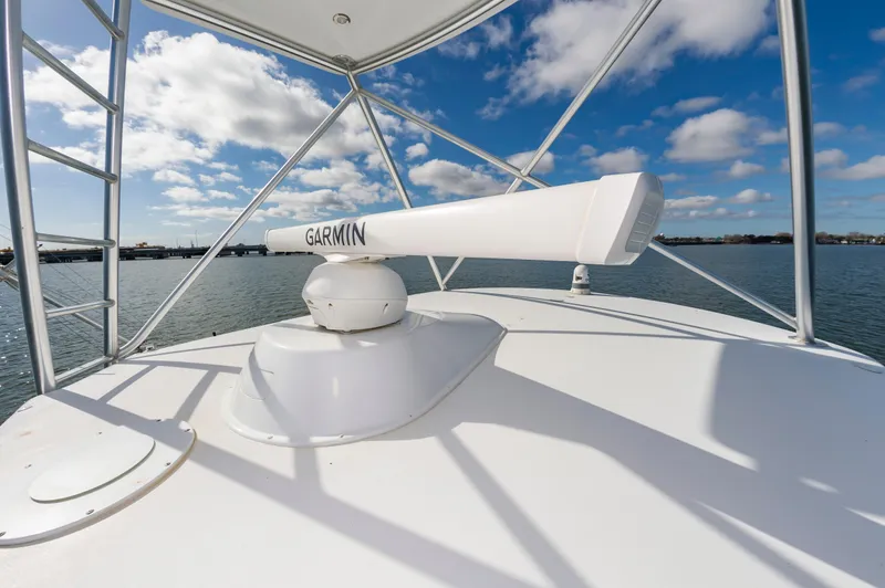 Slide: The Image of 2005 Viking Convertible boat with Garmin radar on open water under blue sky. - 20