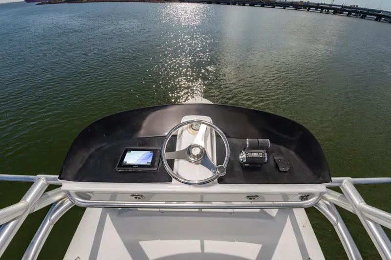 Slide: The Image of Helm of 2005 Viking Convertible boat with steering wheel and navigation equipment. - 25