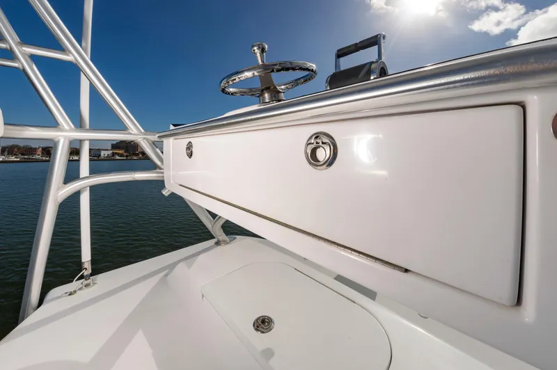 Slide: The Image of 2005 Viking Convertible boat helm with steering wheel, under clear blue sky. - 26