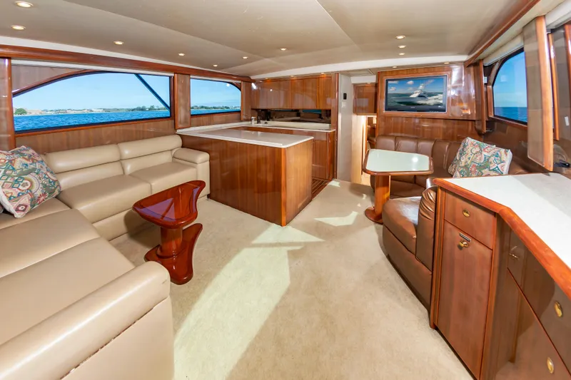 Slide: The Image of Luxurious interior of a 2005 Viking Convertible yacht with elegant wood finishes and plush seating. - 27