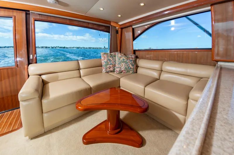 Slide: The Image of Luxurious interior of a 2005 Viking Convertible yacht with beige leather seating and ocean view. - 28