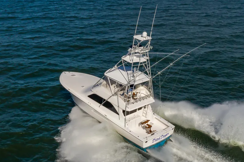 Slide: The Image of 2005 Viking Convertible yacht cruising on open water, showcasing sleek design and powerful performance. - 3