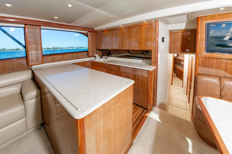 Slide: The Image of Luxurious interior of a 2005 Viking Convertible yacht with elegant wood finishes and modern amenities. - 30