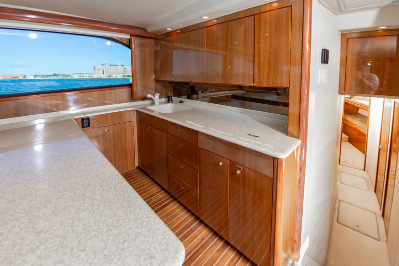 Slide: The Image of Luxurious 2005 Viking Convertible yacht kitchen with wooden cabinetry and ocean view. - 31