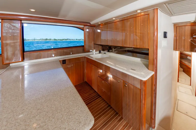 Slide: The Image of Luxurious kitchen interior of 2005 Viking Convertible yacht with wood cabinetry and ocean view. - 32