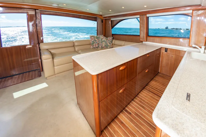 Slide: The Image of Luxurious interior of a 2005 Viking Convertible yacht with ocean views and elegant wood finishes. - 36