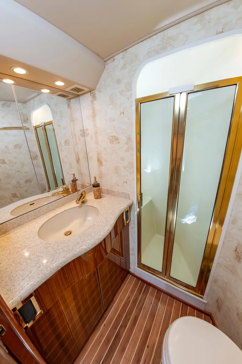 Slide: The Image of Luxurious bathroom in 2005 Viking Convertible yacht with elegant fixtures and wooden flooring. - 43