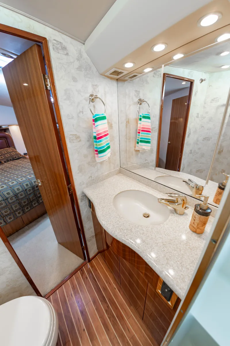 Slide: The Image of Luxurious bathroom in a 2005 Viking Convertible yacht with modern fixtures and elegant design. - 45