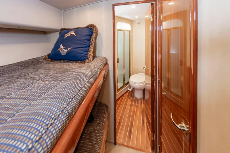 Slide: The Image of 2005 Viking Convertible yacht interior with cozy bunk bed and ensuite bathroom. - 46